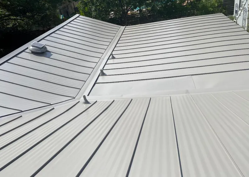 Solar attic fan installed on a metal roof for Roof Ventilation in Highland Lakes